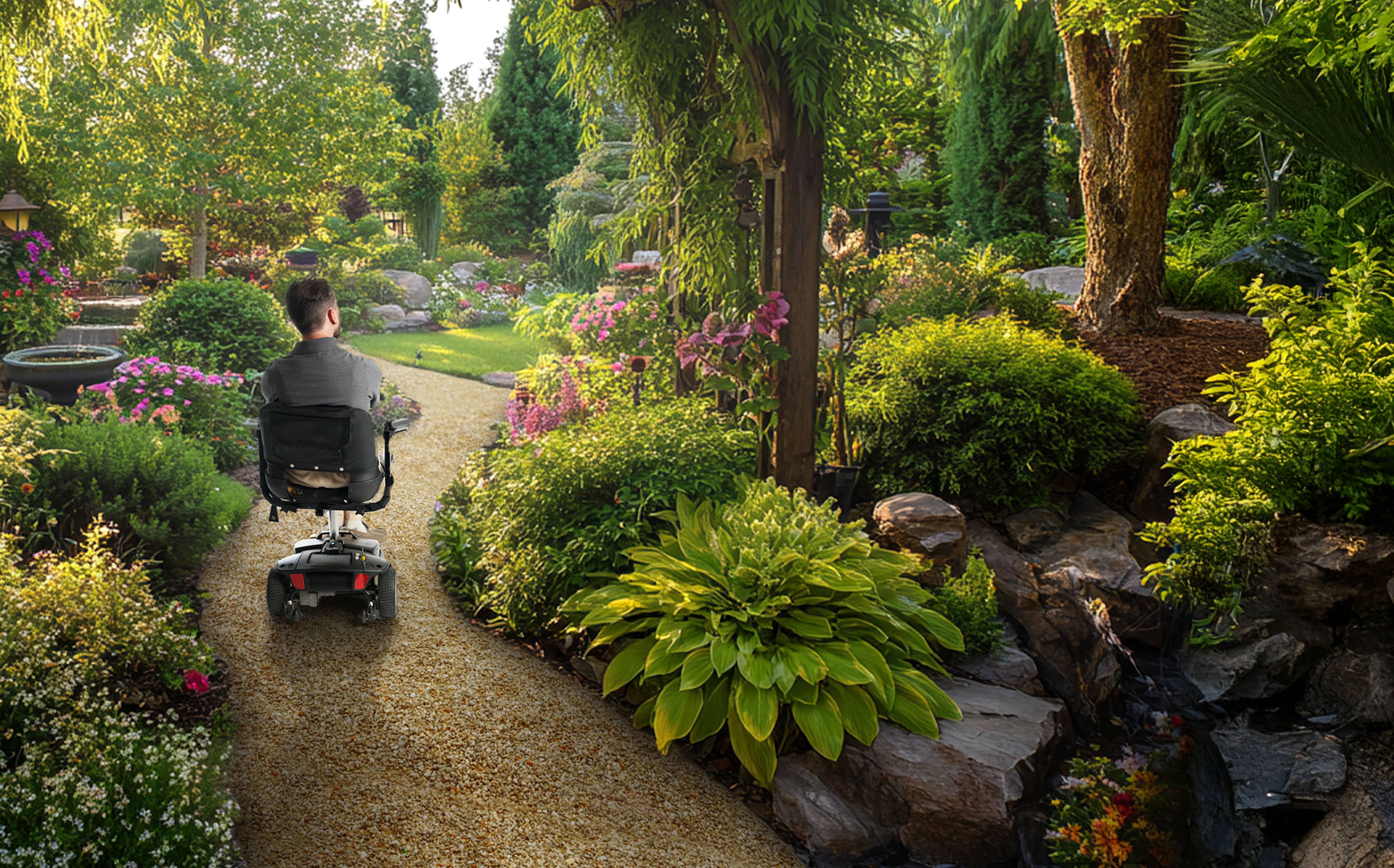 A young man with Friedreich's ataxia riding in a motorized chair on a stone path in a lush, green forest.